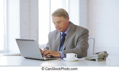 Old man with laptop computer drinking coffee. Business, office, oldness,  school and education concept - old man working with | CanStock