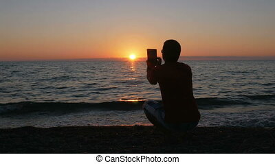 Silhouette Man With Digital Tablet Taking Photo At Sunset Beach The Sun Is Almost Set Behind The Ocean Silhouette Man With Canstock