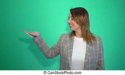 Happy cheerful woman presenting copyspace on her palm isolated over green  background chromakey. | CanStock