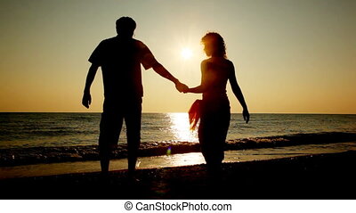 Girl And Boy Go At Beach Holding Hands For Sea Silhouettes On Sunset Part1 Girl And Boy Go At Beach Holding Hands For Sea Canstock